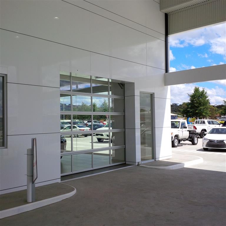 Full vision glass sectional door car showroom